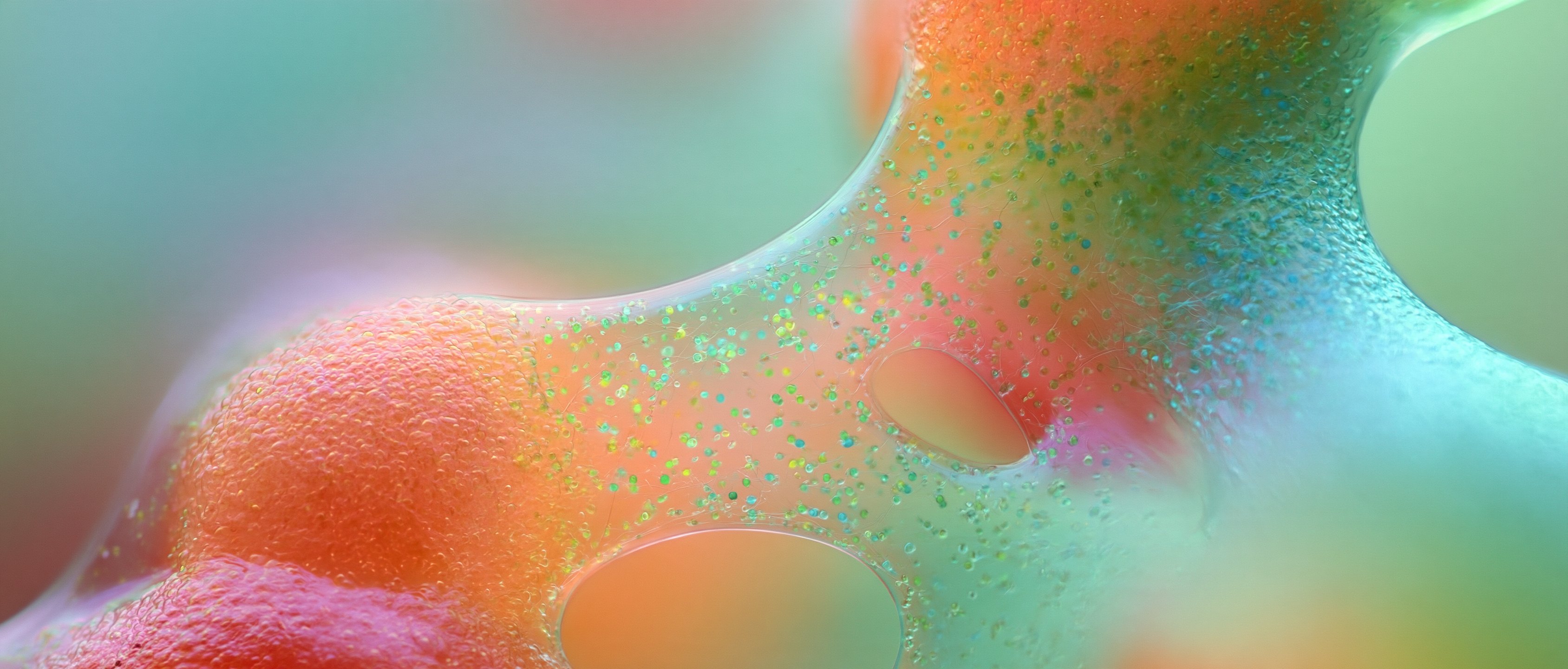 Coral forms pressing against a teal membrane pierced with openings